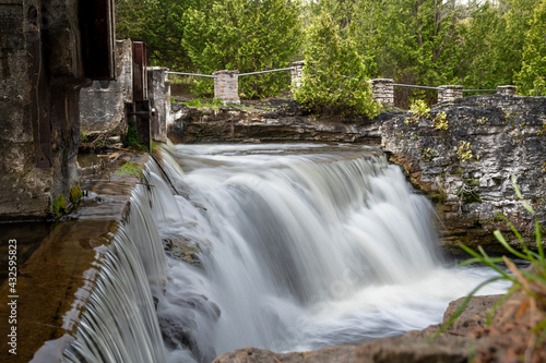 Rockwood Falls flows down the river in Rockwood Conservation Area beside the ruins of an old woollen mill.