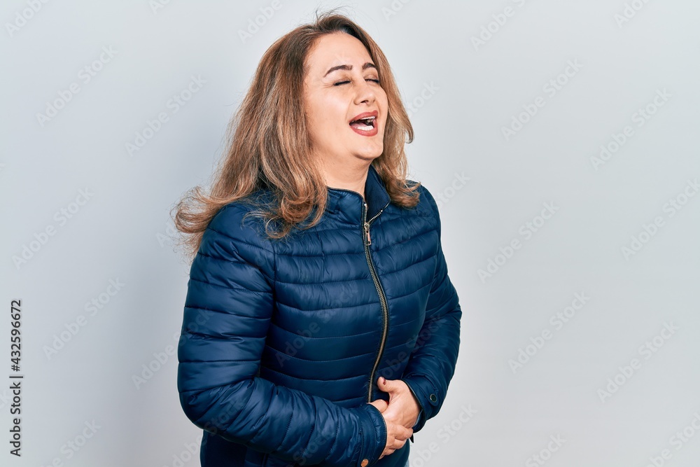 Middle age caucasian woman wearing casual clothes with hand on stomach because nausea, painful disease feeling unwell. ache concept. Middle age caucasian woman wearing casual clothes with hand on stomach because nausea, painful disease feeling unwell. ache concept.