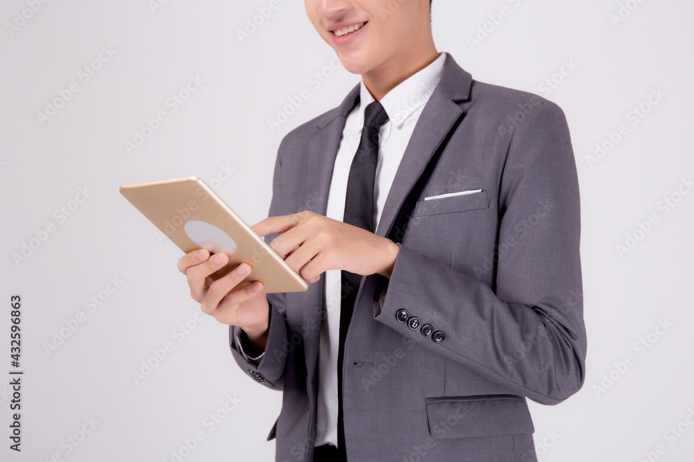 Portrait young asian business man in suit standing using tablet computer to internet isolated on white background, businessman confident touch screen digital pad with success, communication concept. Portrait young asian business man in suit standing using tablet computer to internet isolated on white background, businessman confident touch screen digital pad with success, communication concept.