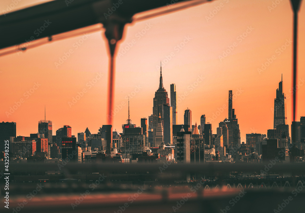 city skyline at sunset panorama Empire State buildings new York sky orange 