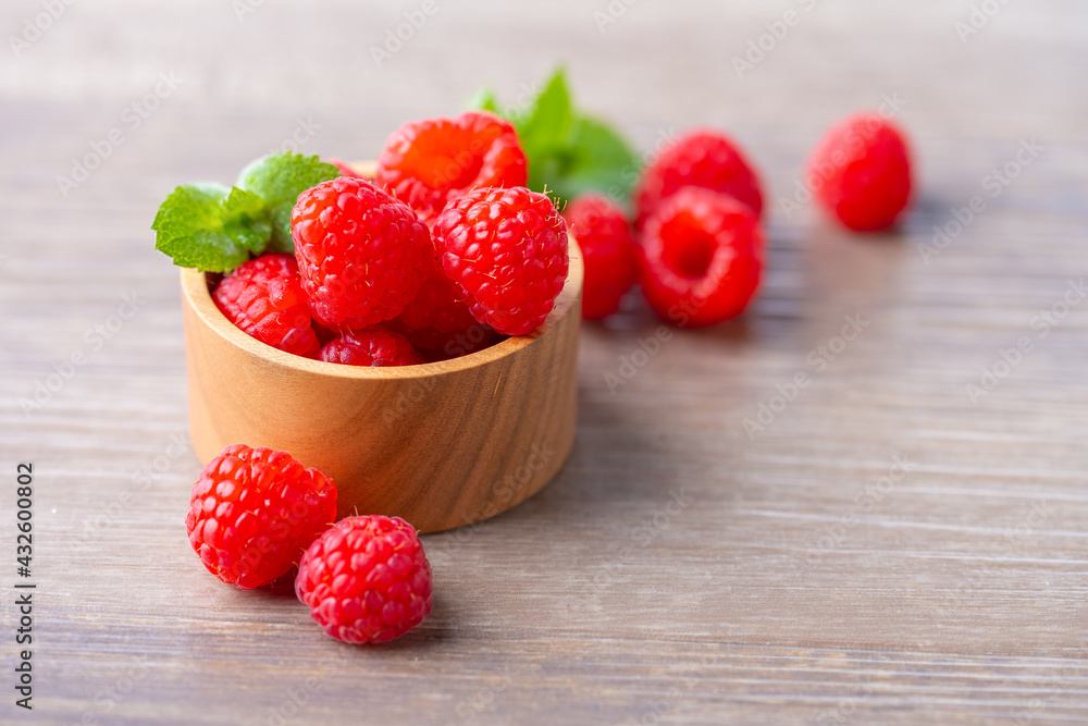 Fresh raspberries on wooden board.
Fresh raspberries on wooden board.