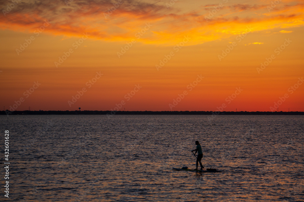 silhouette of a person with paddle board