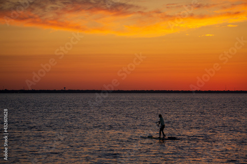 silhouette of a person with paddle board © LuRe Photography