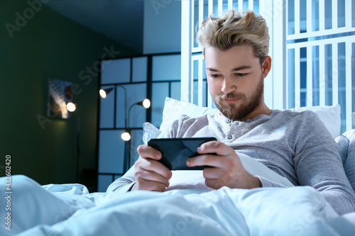Young man with mobile phone...