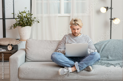 Young man with laptop at home