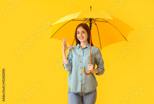 Stylish young woman with um...