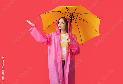 Stylish young woman in rain...
