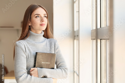 Bild auf Leinwand Young woman with Bible at home