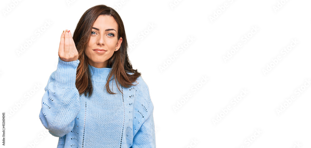Young brunette woman wearing casual winter sweater doing italian gesture with hand and fingers confident expression Young brunette woman wearing casual winter sweater doing italian gesture with hand and fingers confident expression