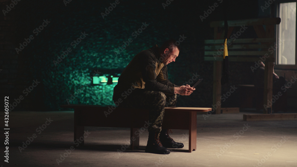 Male soldier making video call in gym Male soldier making video call in gym