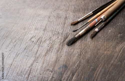 old brushes on wooden background