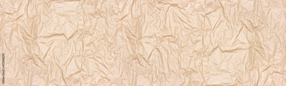 Fototapeta premium Crumpled kraft packing paper wide texture. Wrinkled recycled brown paper sheet widescreen backdrop. Large abstract banner background