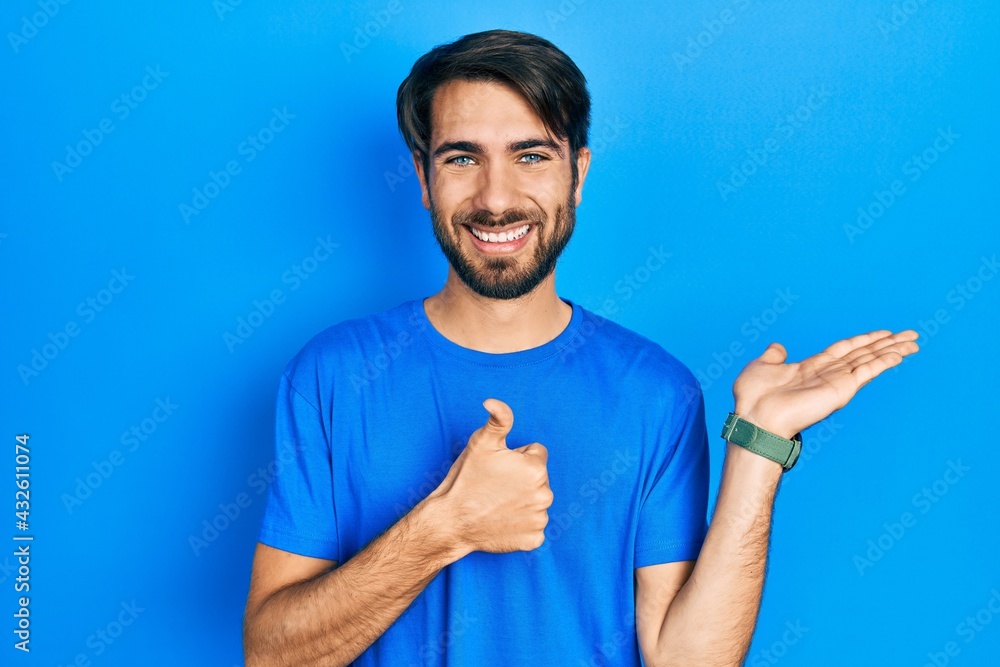 Young hispanic man wearing casual clothes showing palm hand and doing ok gesture with thumbs up, smiling happy and cheerful Young hispanic man wearing casual clothes showing palm hand and doing ok gesture with thumbs up, smiling happy and cheerful
