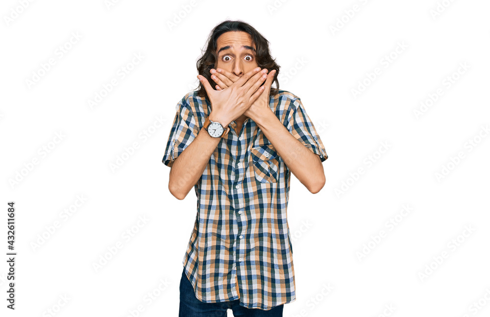 Young hispanic man wearing casual clothes shocked covering mouth with hands for mistake. secret concept. Young hispanic man wearing casual clothes shocked covering mouth with hands for mistake. secret concept.