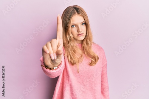 Beautiful young caucasian girl wearing casual clothes pointing with finger up and angry expression, showing no gesture © Krakenimages.com