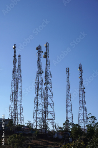 Six transmission towers of mobile phone companies on top of a hillock.