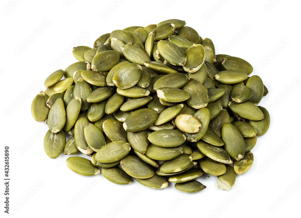 pile of peeled pumpkin seeds closeup on white