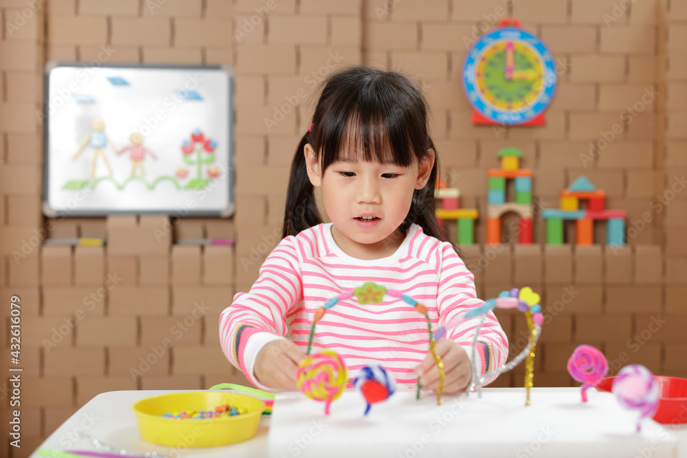 young girl making bead craft at home young girl making bead craft at home