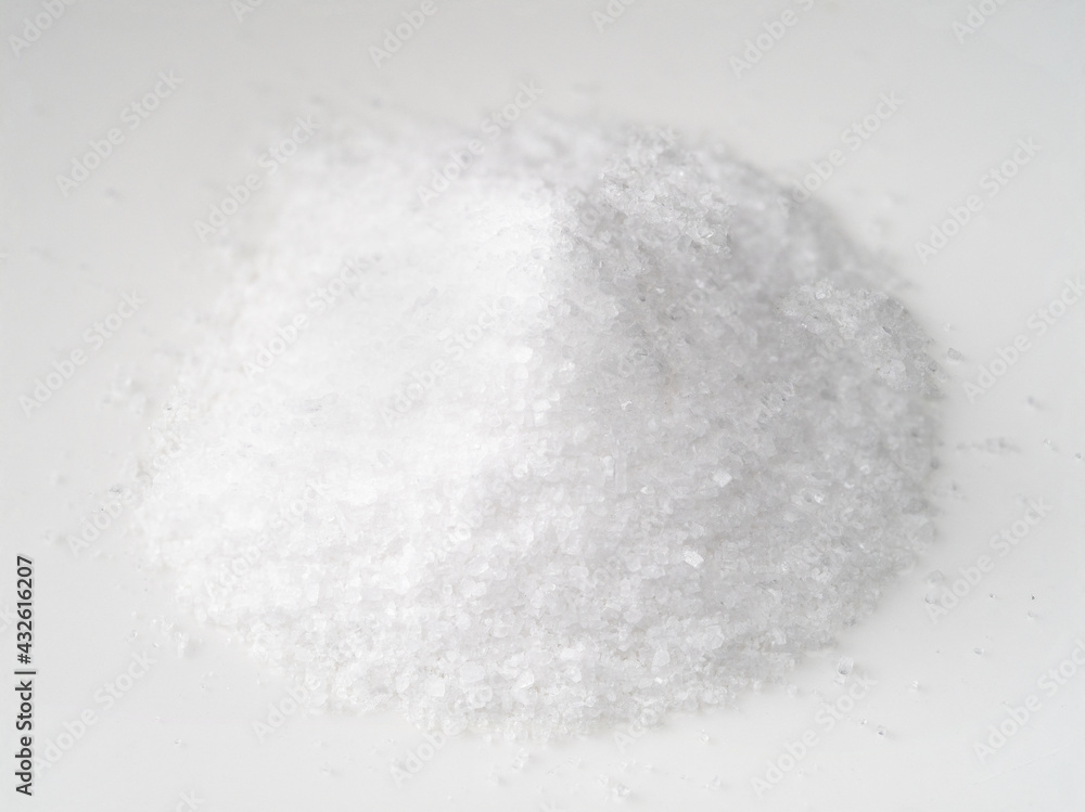 pile of finely ground sea salt closeup on white