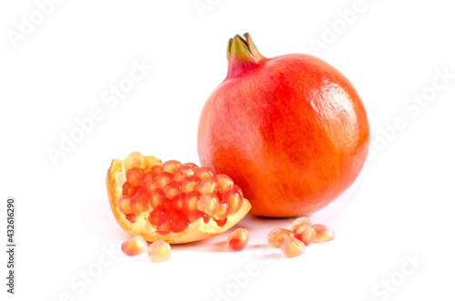 Closed up fresh sweet promegranate seeds and fruit on white background photo