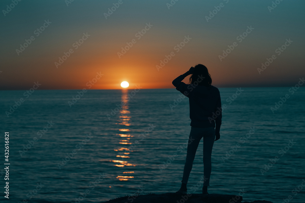 female silhouette gesturing with hands sunset sea model