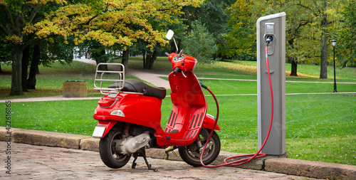 Fototapeta Electric scooter with charging station on a city street