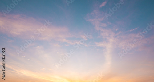 abstract color of pinky sky and white fluffy cumulus clouds with beautiful rays sunbeam shining in the sky. soft smoothness of clouds in summer season. clear weather good air in environment background