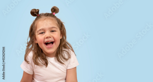 cute girl smiles on a blue background