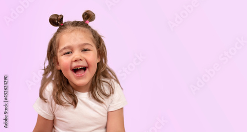 cute girl smiles on a pink background