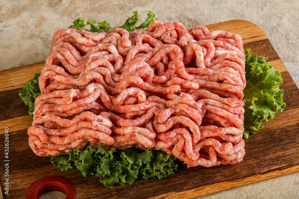 Raw pork minced meat over board Raw pork minced meat over board