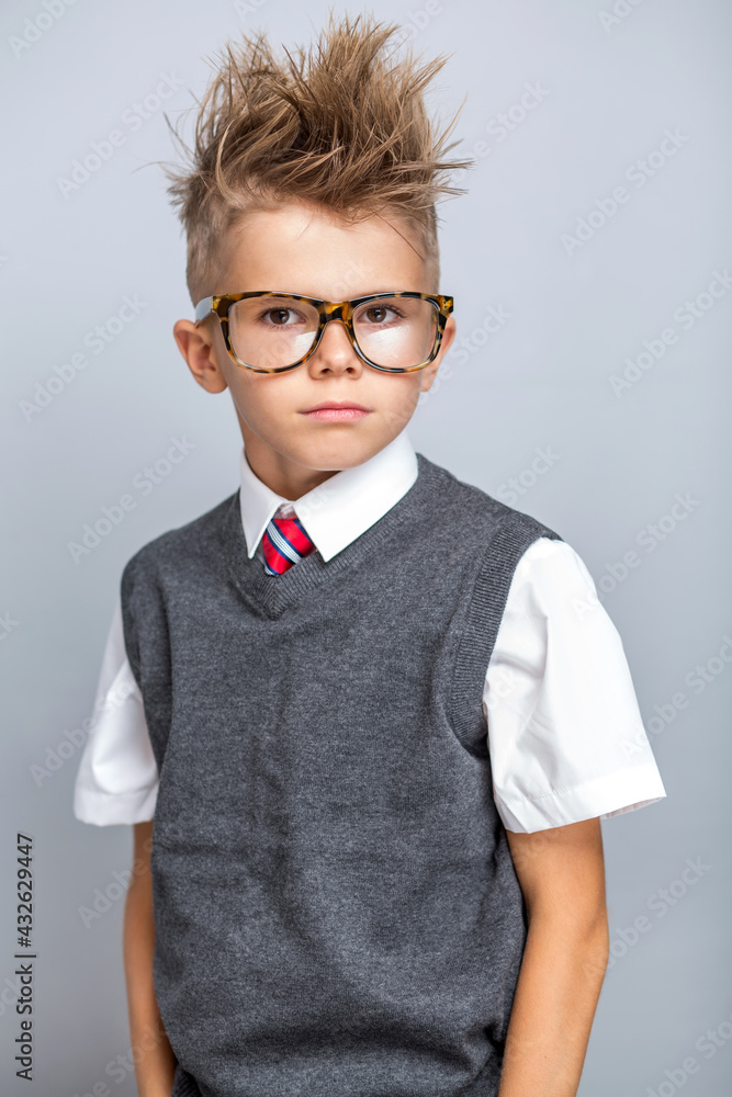 Funny cute little boy in elegant school clothing	