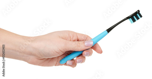 Hand with blue dental toothbrush isolated on white background