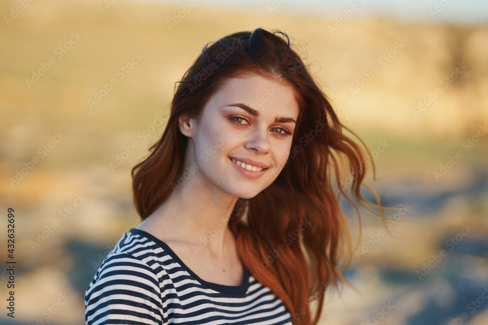 happy woman in striped t-shirt outdoors smiling