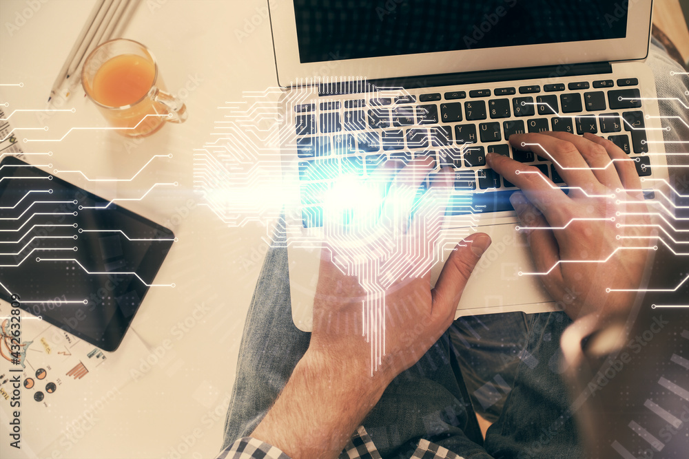 Double exposure of man's hands typing over computer keyboard and brain hologram drawing. Top view. Ai and data technology concept. Double exposure of man's hands typing over computer keyboard and brain hologram drawing. Top view. Ai and data technology concept.