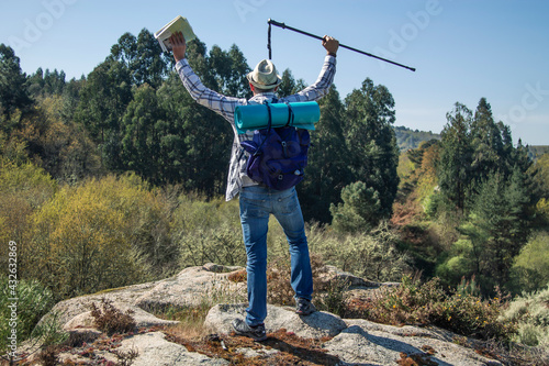 man traveling with backpack and map hiking