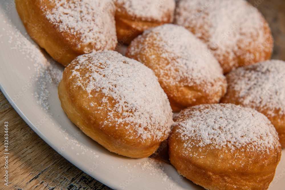 Freshly cooked Apricot jam doughnuts, referred to as jelly doughnuts, donuts in the US, The doughnuts have been fried, injected with a generous amount of jelly, jam and then dipped in caster sugar
