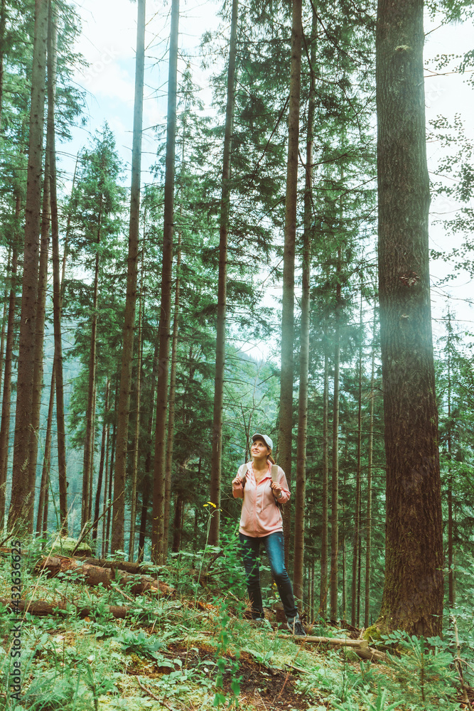 woman backpacker enjoying view of forest in mountains woman backpacker enjoying view of forest in mountains