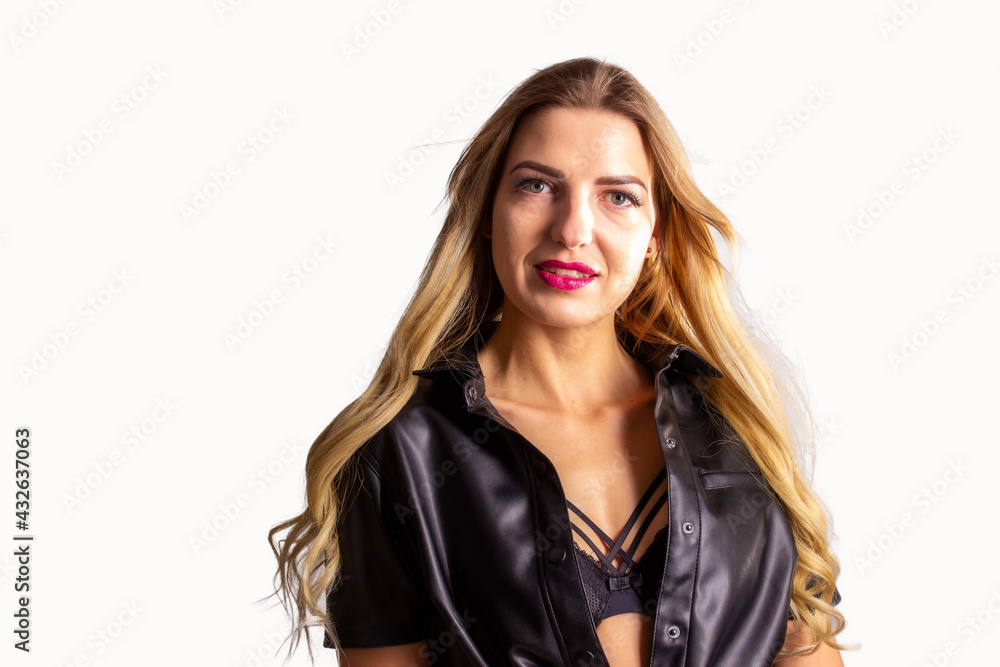 A beautiful young woman in leather clothes is smiling. White background