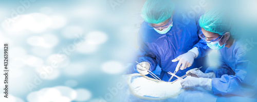 Operating Room of Surgical Table with Instruments, Assistant Picks up Instruments for Surgeons During Operation. Surgery in Progress. Professional Medical Doctors Performing Surgery. photo