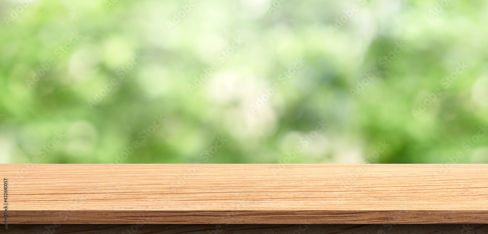 Empty wood table top with bokeh green nature background. Display product for Banner or advertise on social media,spring or summer concept Empty wood table top with bokeh green nature background. Display product for Banner or advertise on social media,spring or summer concept