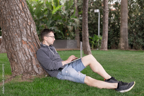 A young man with laptop outdoor. Freelance work from anywhere in the world