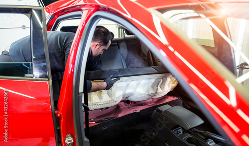 Car service worker disassemble the interior of the car