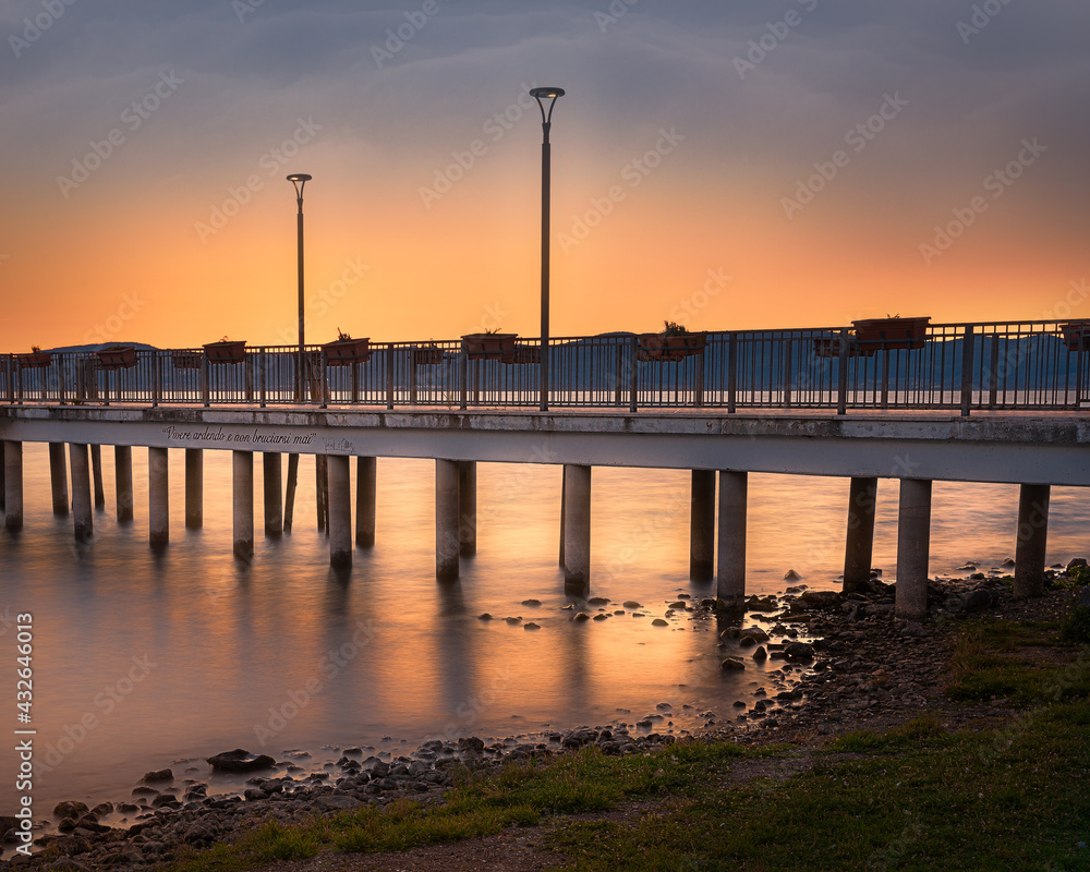 Fototapeta premium jetty at lake sunset sky