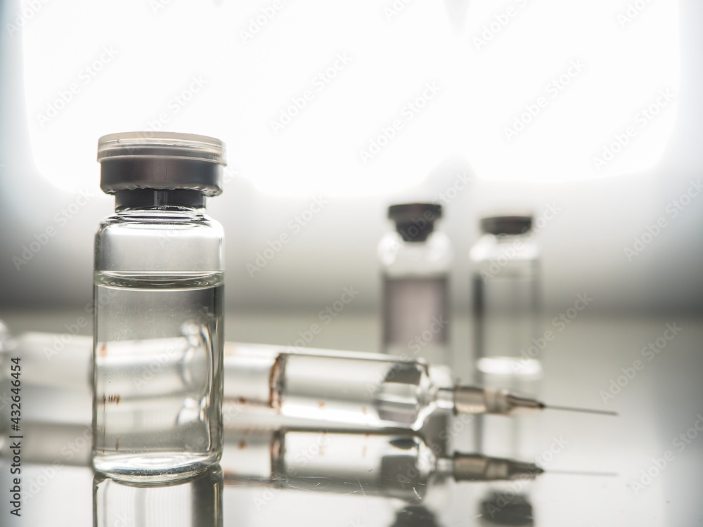 ampoules with Covid-19 vaccine on a laboratory bench. to fight the coronavirus / sars-cov-2 pandemic. Vaccine and syringe injection. It use for prevention, immunization and treatment ampoules with Covid-19 vaccine on a laboratory bench. to fight the coronavirus / sars-cov-2 pandemic. Vaccine and syringe injection. It use for prevention, immunization and treatment