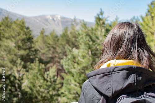 Woman on her back with long hair looking at the landscape.