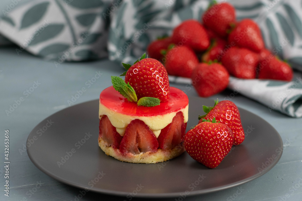 Strawberry dessert on a grey plate and light grey background. Strawberry dessert on a grey plate and light grey background.