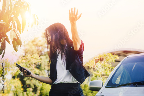 Businesswoman were upset about the outdoor weather on hot days because she had a problem with a damaged car and no telephone signal, contacting anyone : Business women are tired of broken car. photo