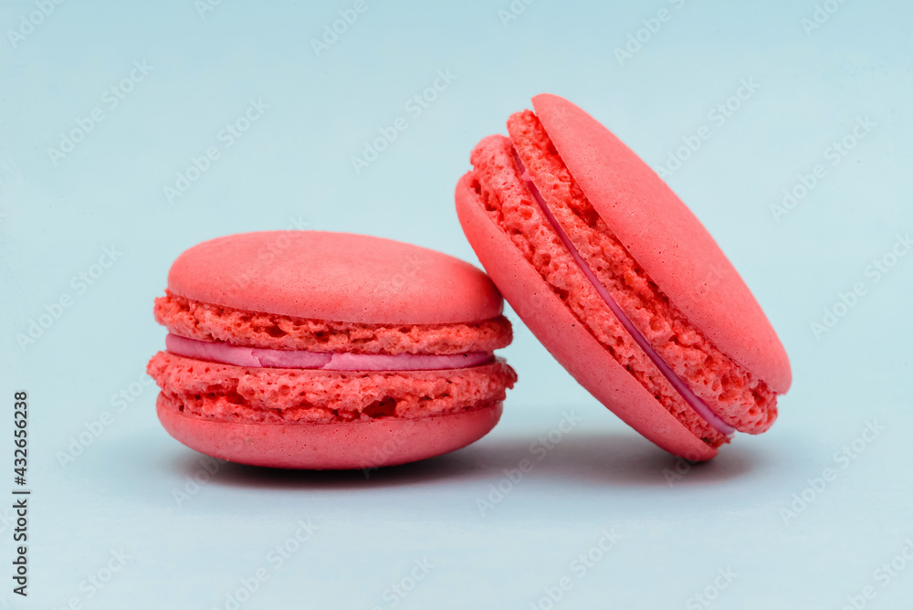 pink macaron cake on a blue paper background pink macaron cake on a blue paper background