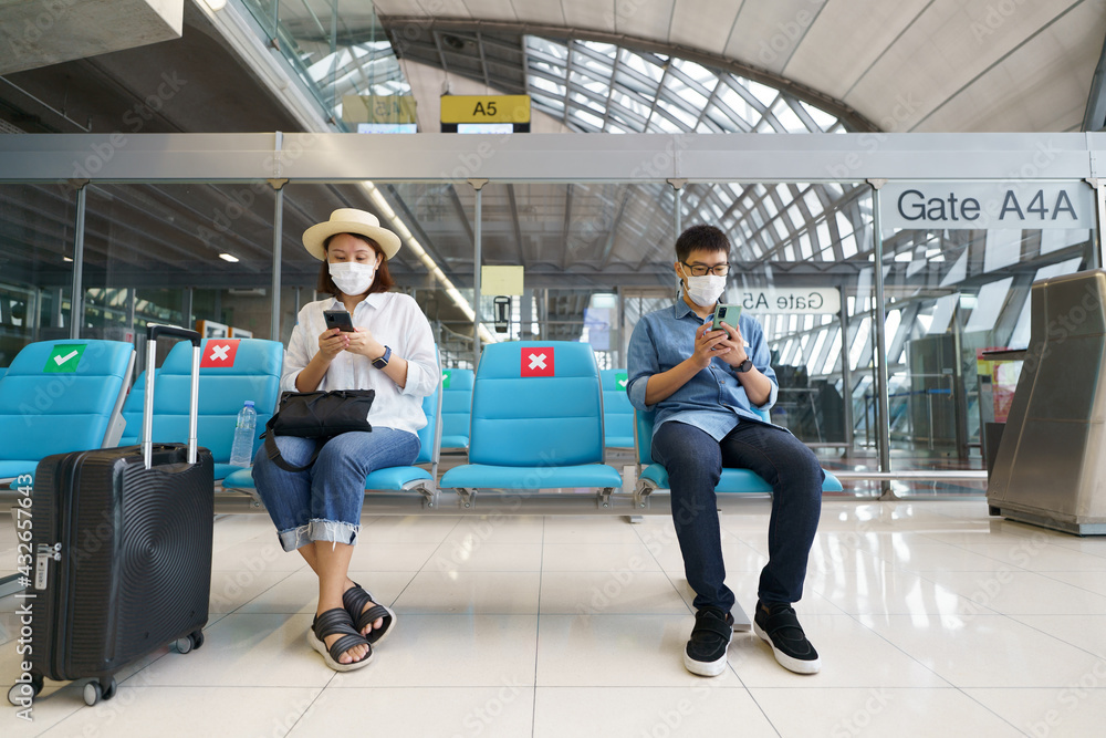 New Normal tourist wearing face mask is traveling on The airport , New lifestyle travel after covid-19. Social distancing healthcare system ,stay safe and Travel bubble concept.