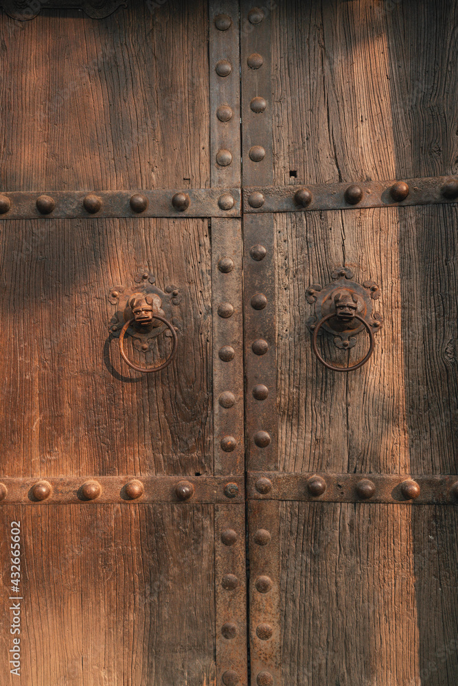 Retro lion head iron door knocker on ancient Chinese wooden door Retro lion head iron door knocker on ancient Chinese wooden door